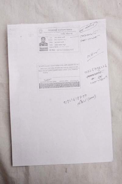 <p>Government of the People’s Republic of Bangladesh    <br />NATIONAL ID CARD<br />[front]<br />[Handwritten] Name change<br />NAME: Mohd Hazrat Ali [Handwritten, on poster] Solaiman    <br />FATHER: Mohd Jonab Ali [Handwritten, on poster] Father - Haider<br />MOTHER: Mosammat Hajra Khatun<br />Date of Birth: 01 Dec 1982<br />ID NO: 8816729586141<br />[back] <br />This card is the property of the government of Bangladesh.  If the card is not found on the user, you are requested to submit it at the nearest post office.<br />ADDRESS: VILLAGE/ROAD: Mulkandi, Mulkandi, POST OFFICE: Beltoil – 6770, Shahzadpur, Sirajganj<br />Signature of the authorising officer [illegible]<br />Date given: 27/07/2008<br />~ ~ ~ ~ ~ ~ ~ ~ ~ ~ <br />[Handwritten] 3rd floor<br />01725095226<br />Hajra Khatun<br />01821618700 Rabiul (mama) [mother’s brother]</p>